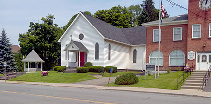 SUMCeast Pictured above: a view of the Stamford United Methodist Church and the Stamford Village Hall, looking North across Main St / Route 23.